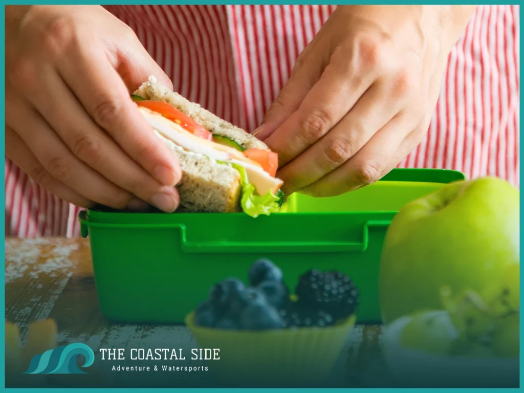 Green plastic container with a sandwich for lunch