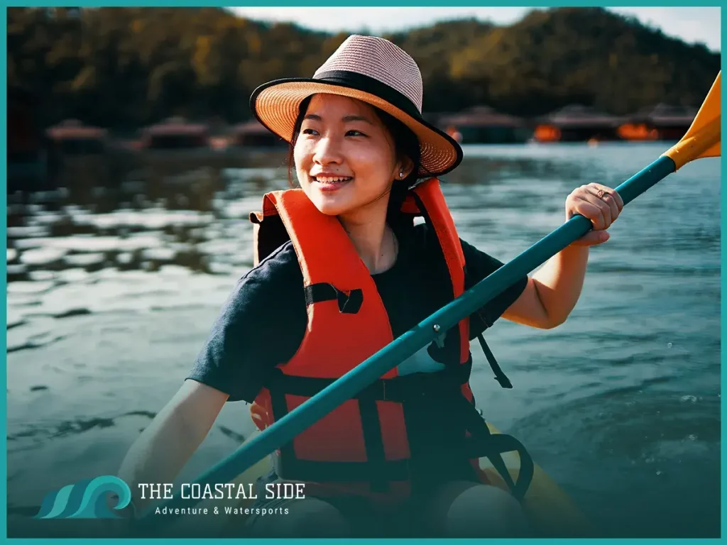 Woman in a life vest and hat kayaking