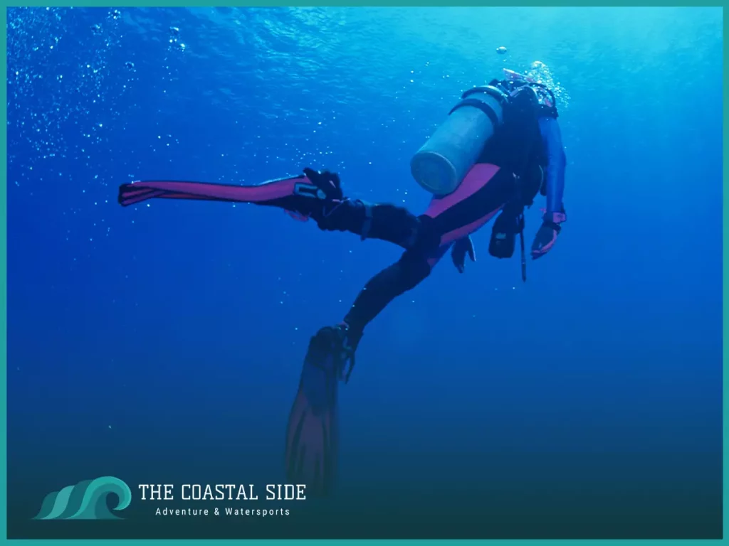 Scuba diver in the blue ocean water