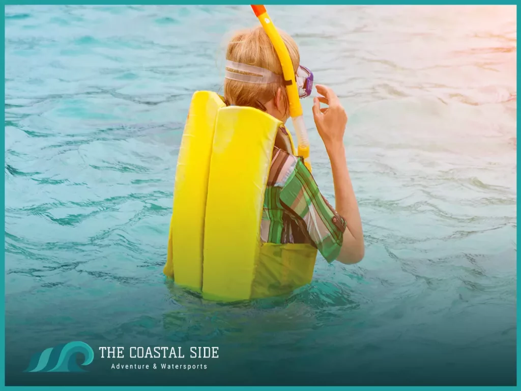 Person snorkeling with a yellow life jacket