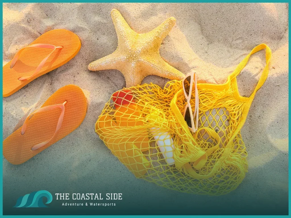 Yellow mesh beach bag with orange flip flops and starfish