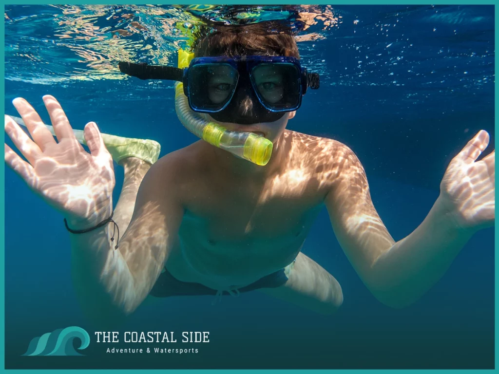 Kid snorkeling just under the water surface