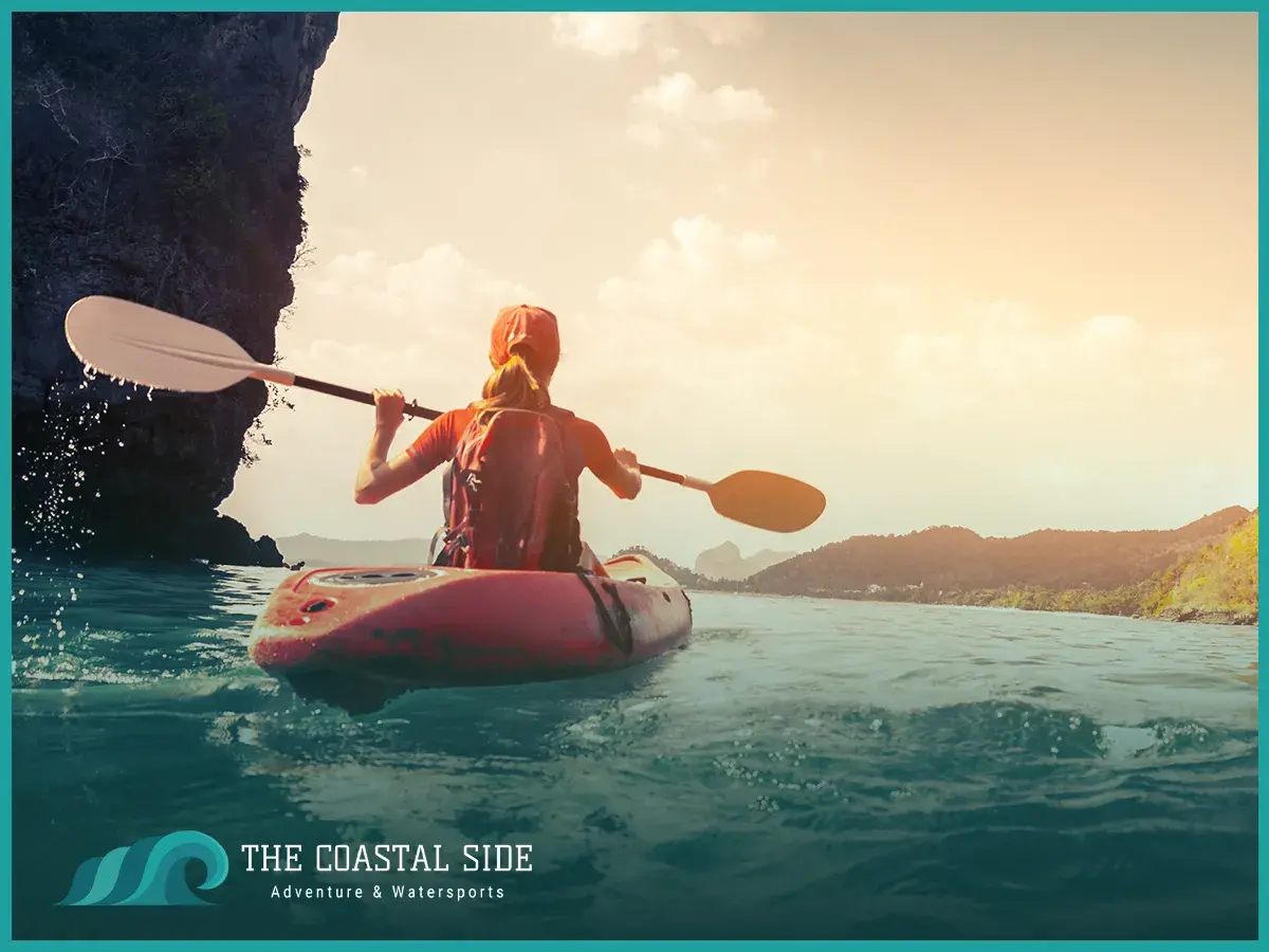 A woman kayaking in a lake canyon