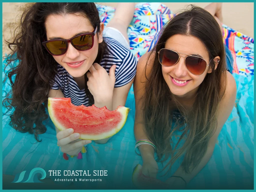 Two women eating a fresh watermelon