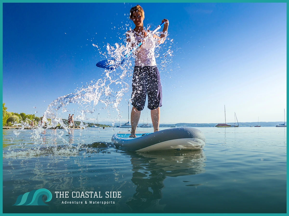 A man on a sup splashing around with the paddle