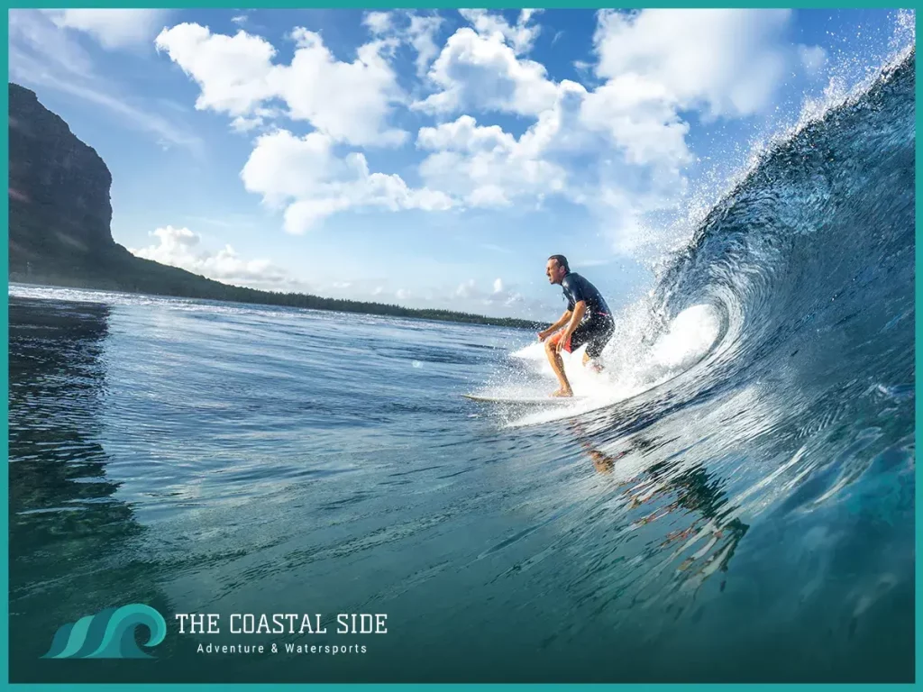 Man riding the waves on a white surfboard