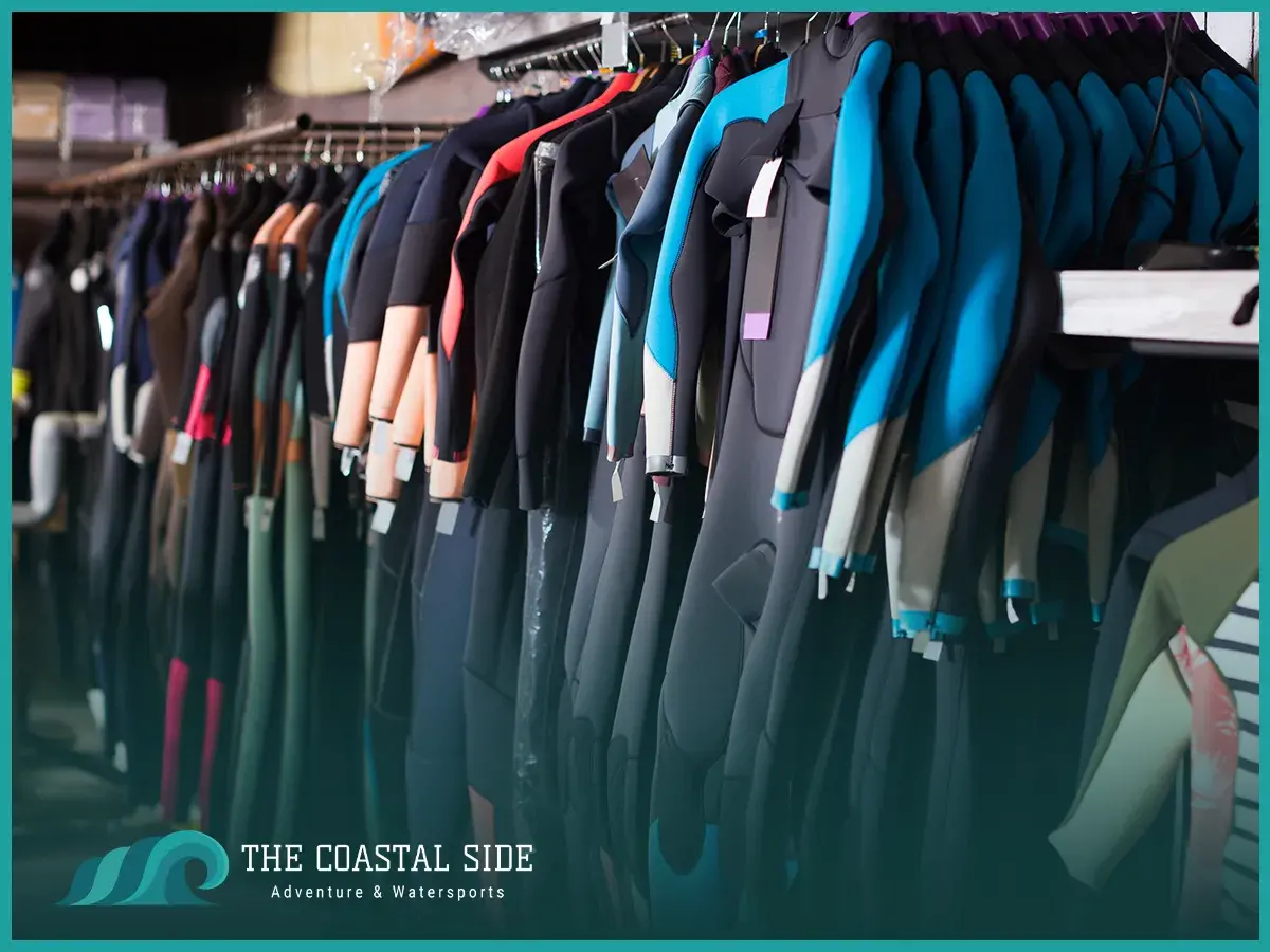 Many wetsuits in a surf shop