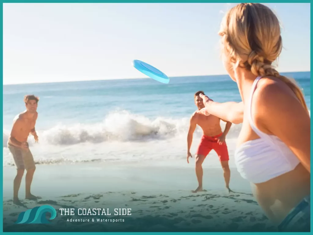 Man in red swim trunks playing frisbee on the beach