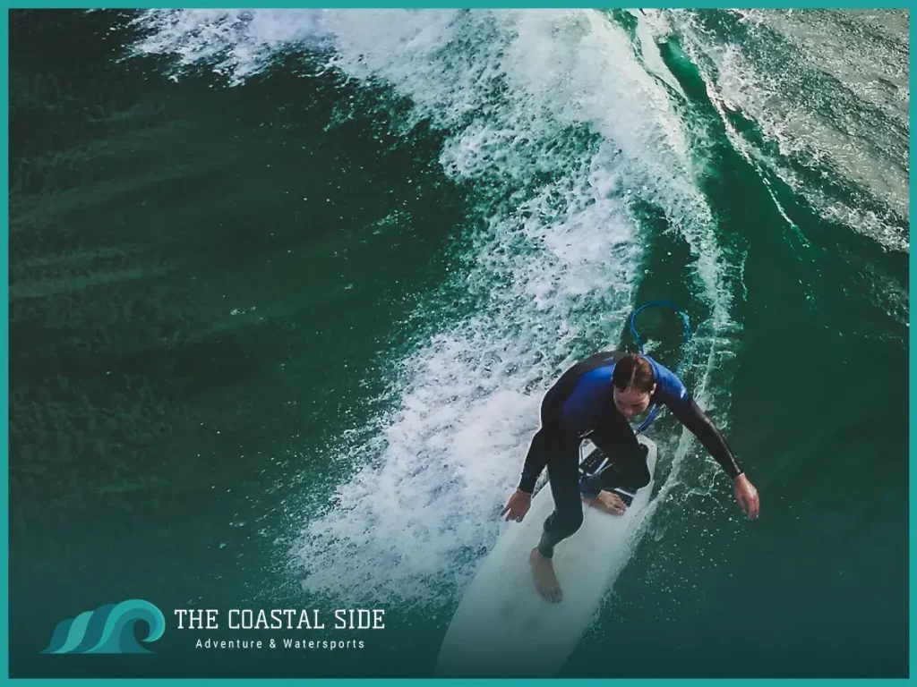 Birds eye view of a man riding a white shortboard surfboard