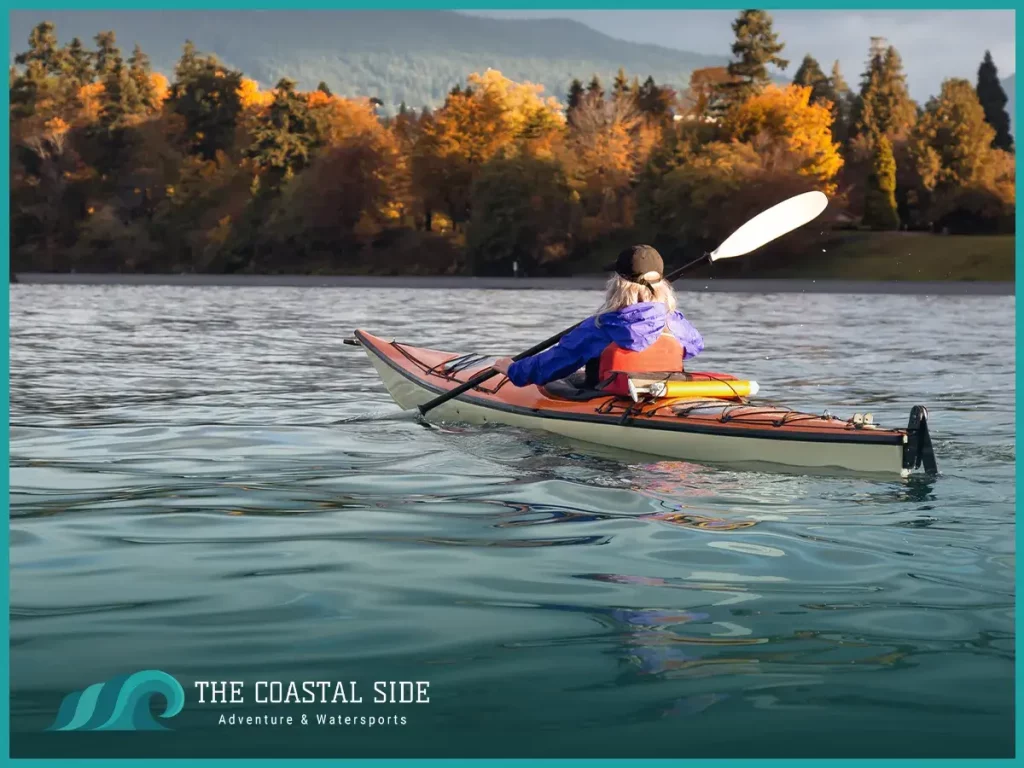 Persona kayaking amongst the fall colored leaves