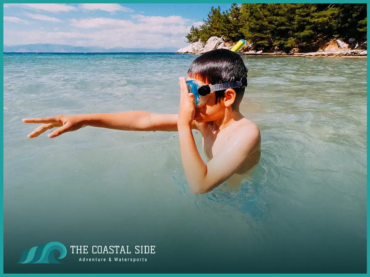 A young boy practicing how to snorkel