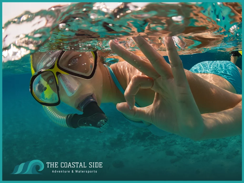 Woman snorkeling giving an ok sign to the camera