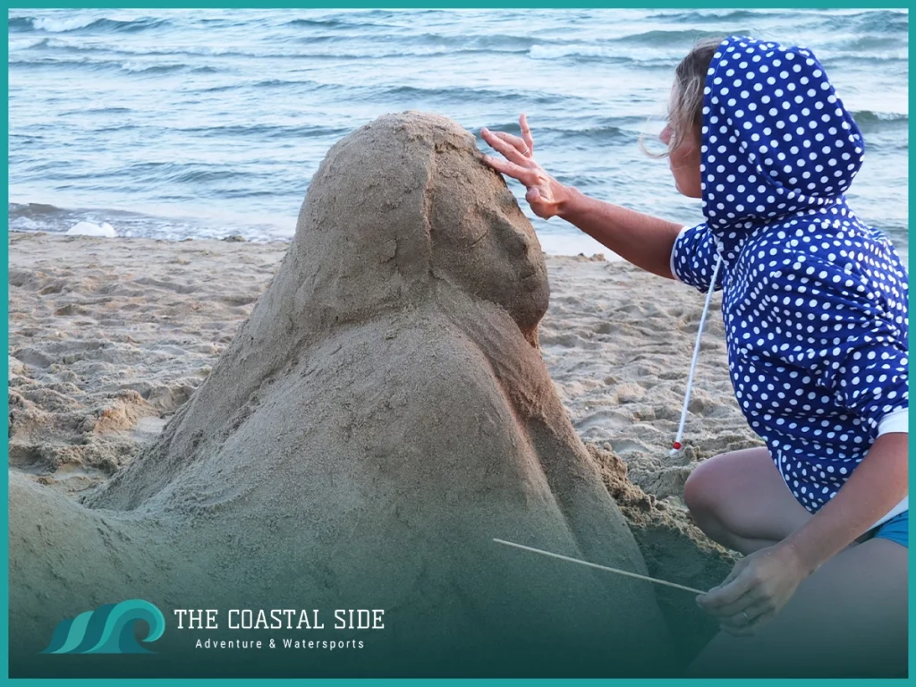 Building a large sandcastle on the beach