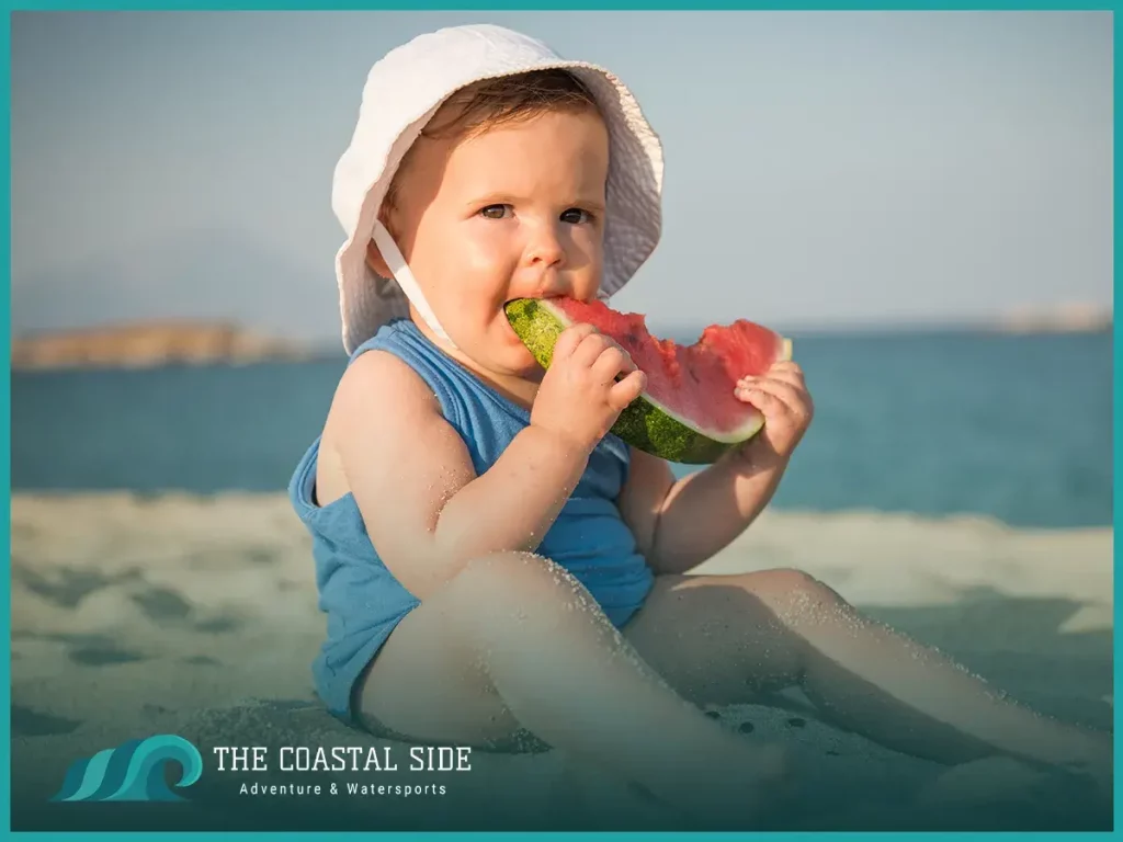 Baby eating a watermelon at the beach