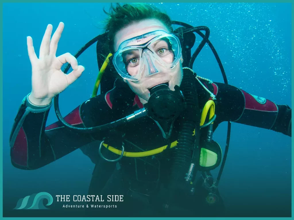 Woman giving an ok hand signal underwater