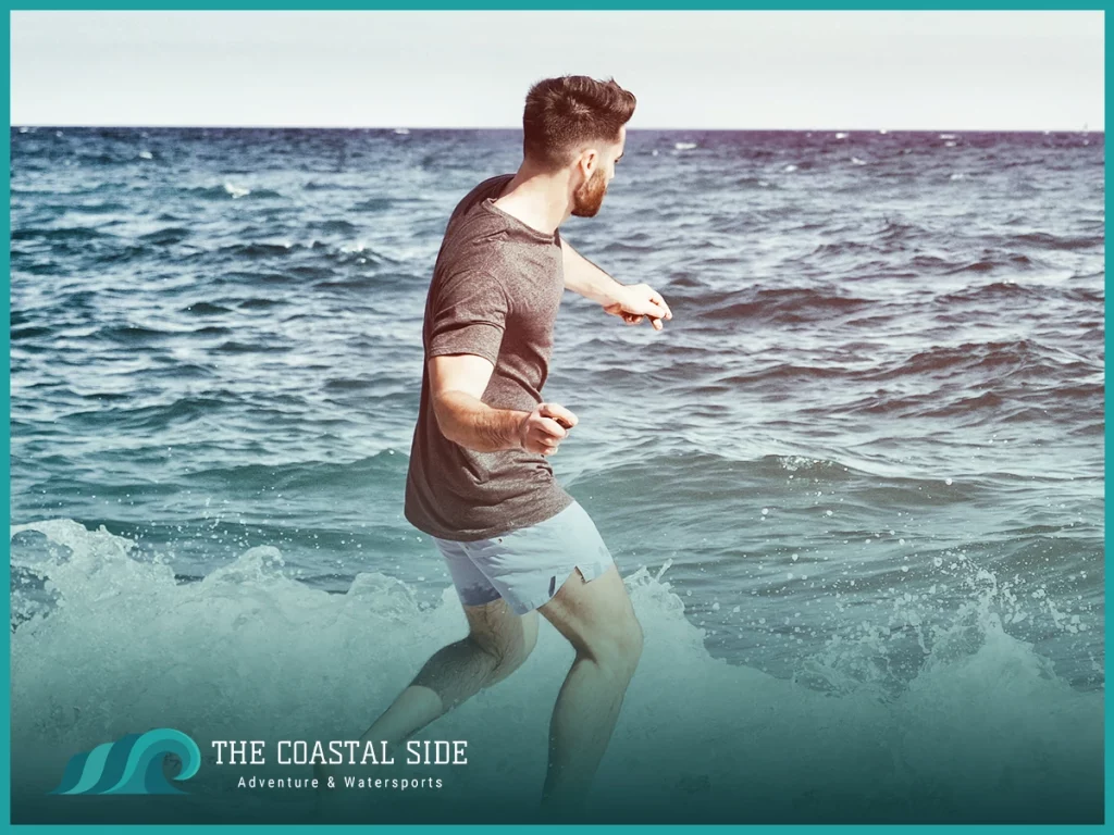 Young man skipping rocks at the ocean