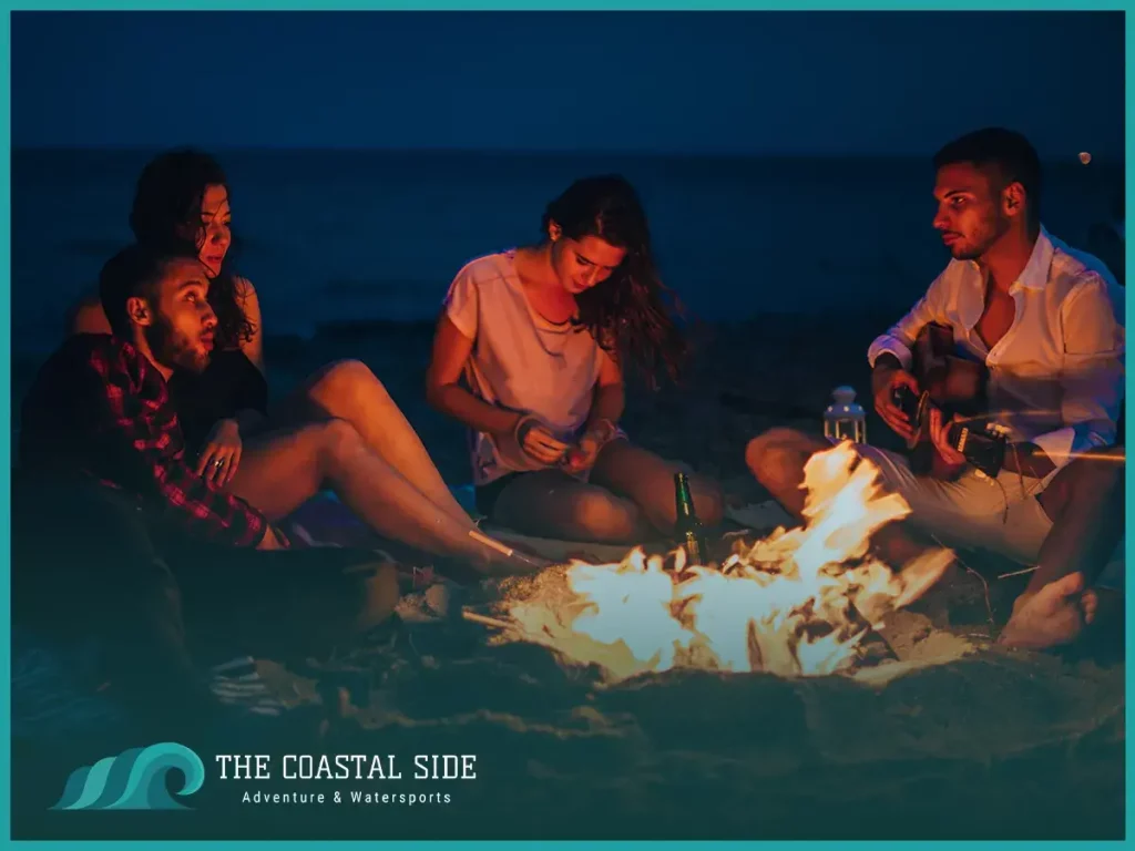 Group of friends having a bonfire on the shore