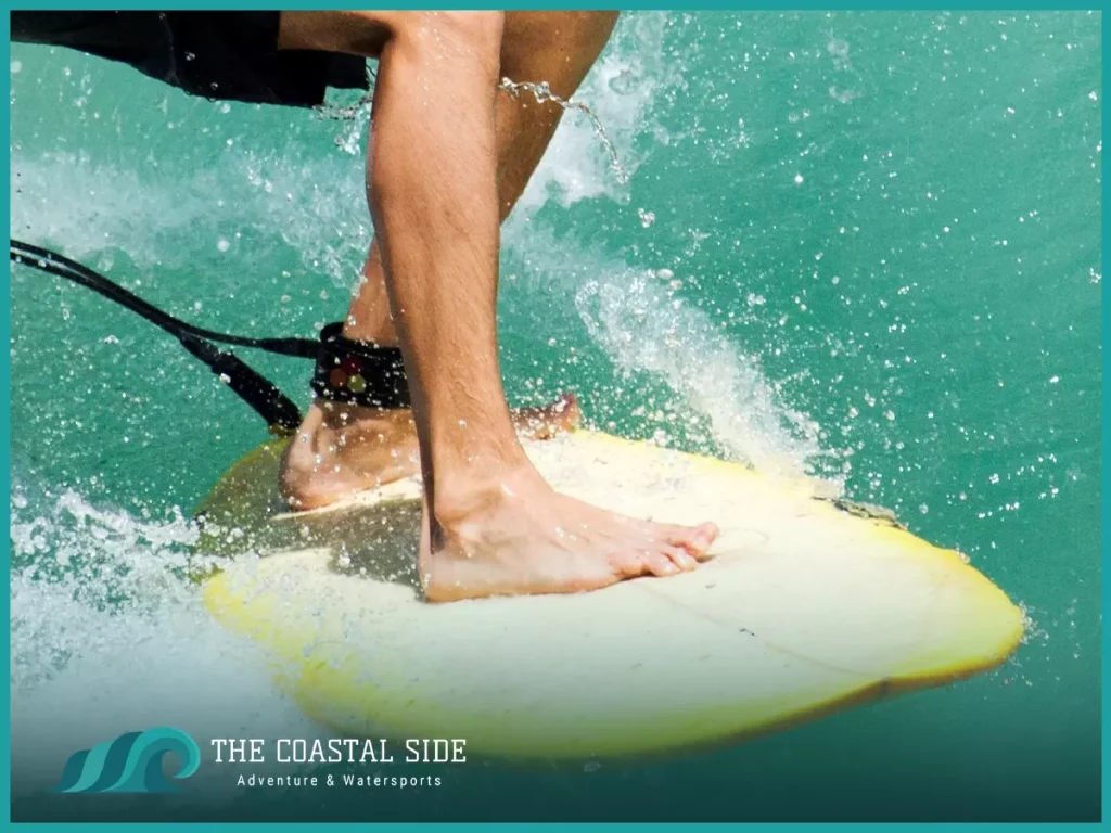 Man riding on a surf board with a surf leash attached