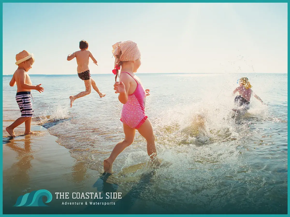 Little kids playing in the waves at the ocean