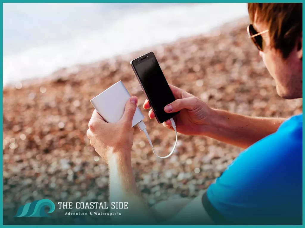 Cell phone charger being used at the beach