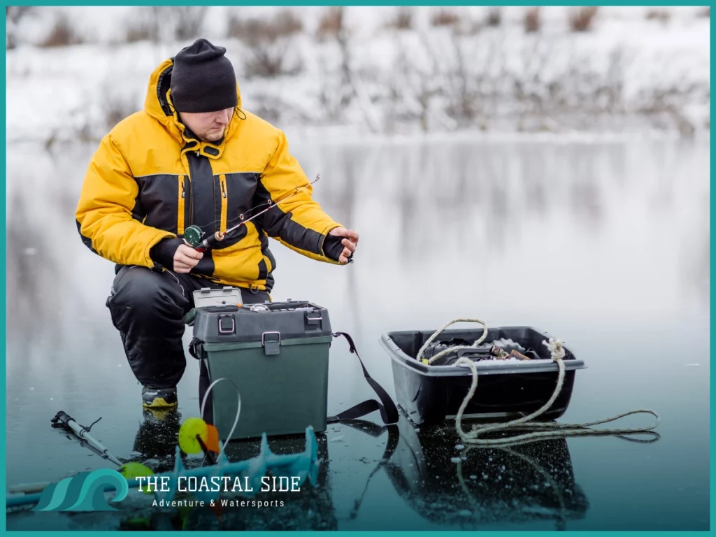 Man in yellow jacket on a frozen lake ice fishing