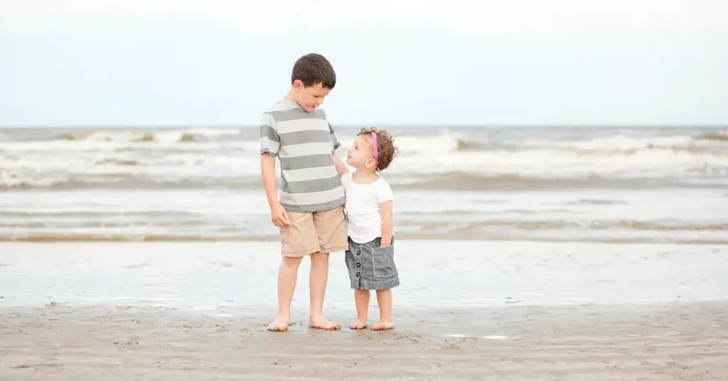 a boy and girl standing on Texas white sand beaches
